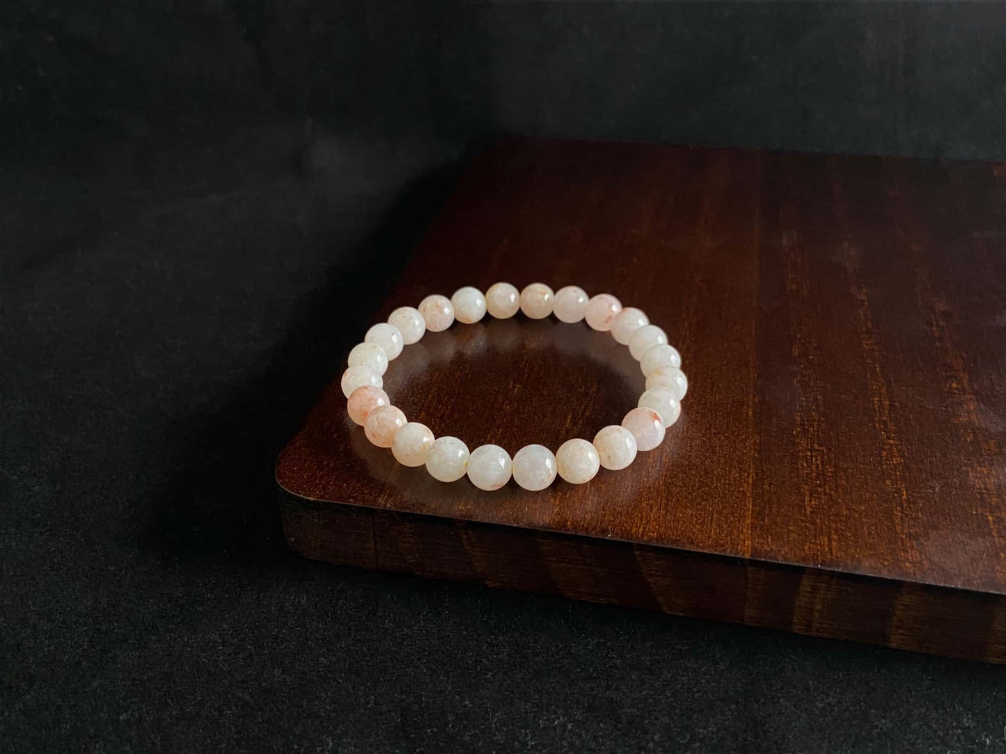 A warm peach tone jadeite beads bracelet.