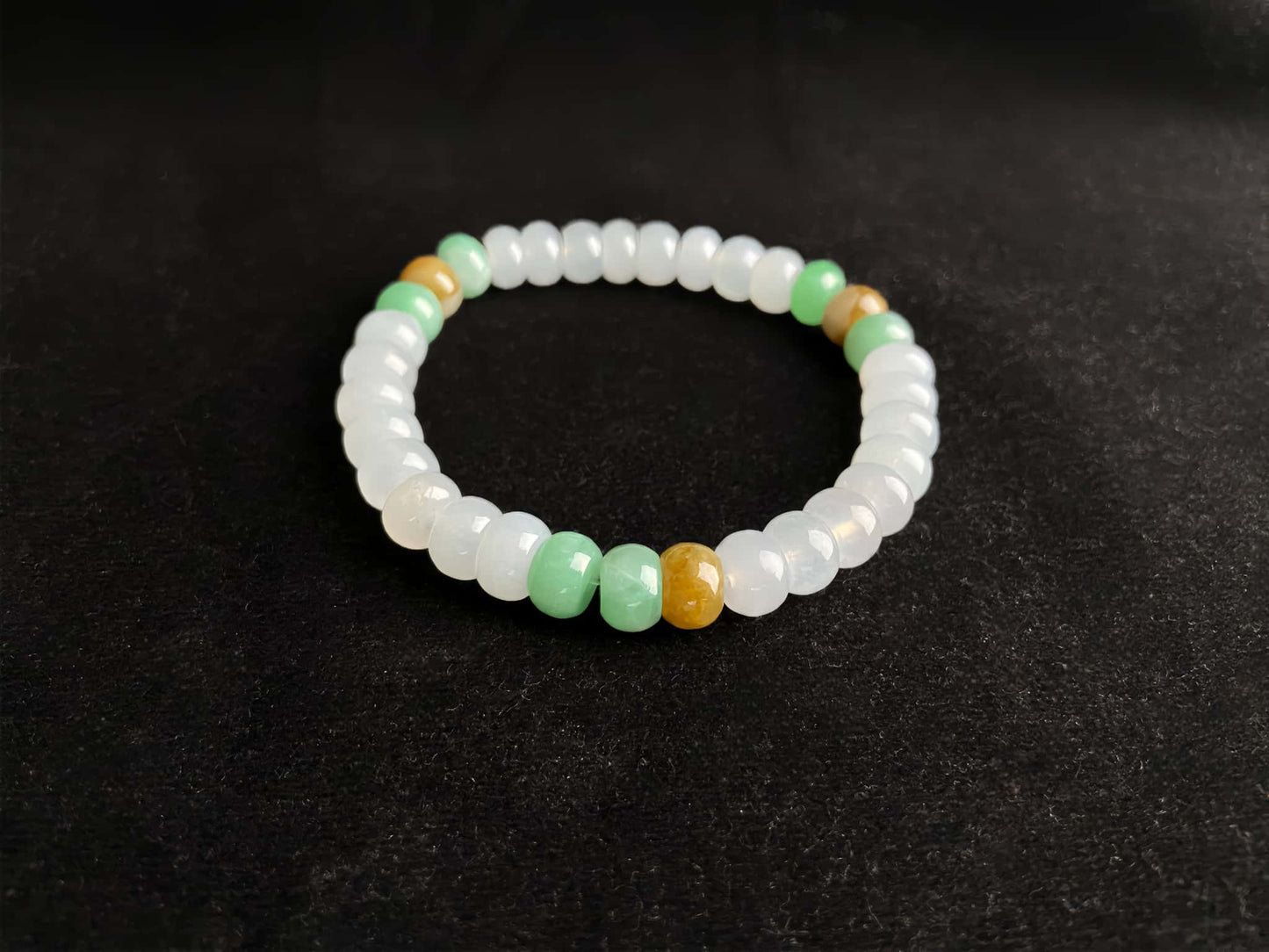 A golden green white blessing jadeite beads bracelet.