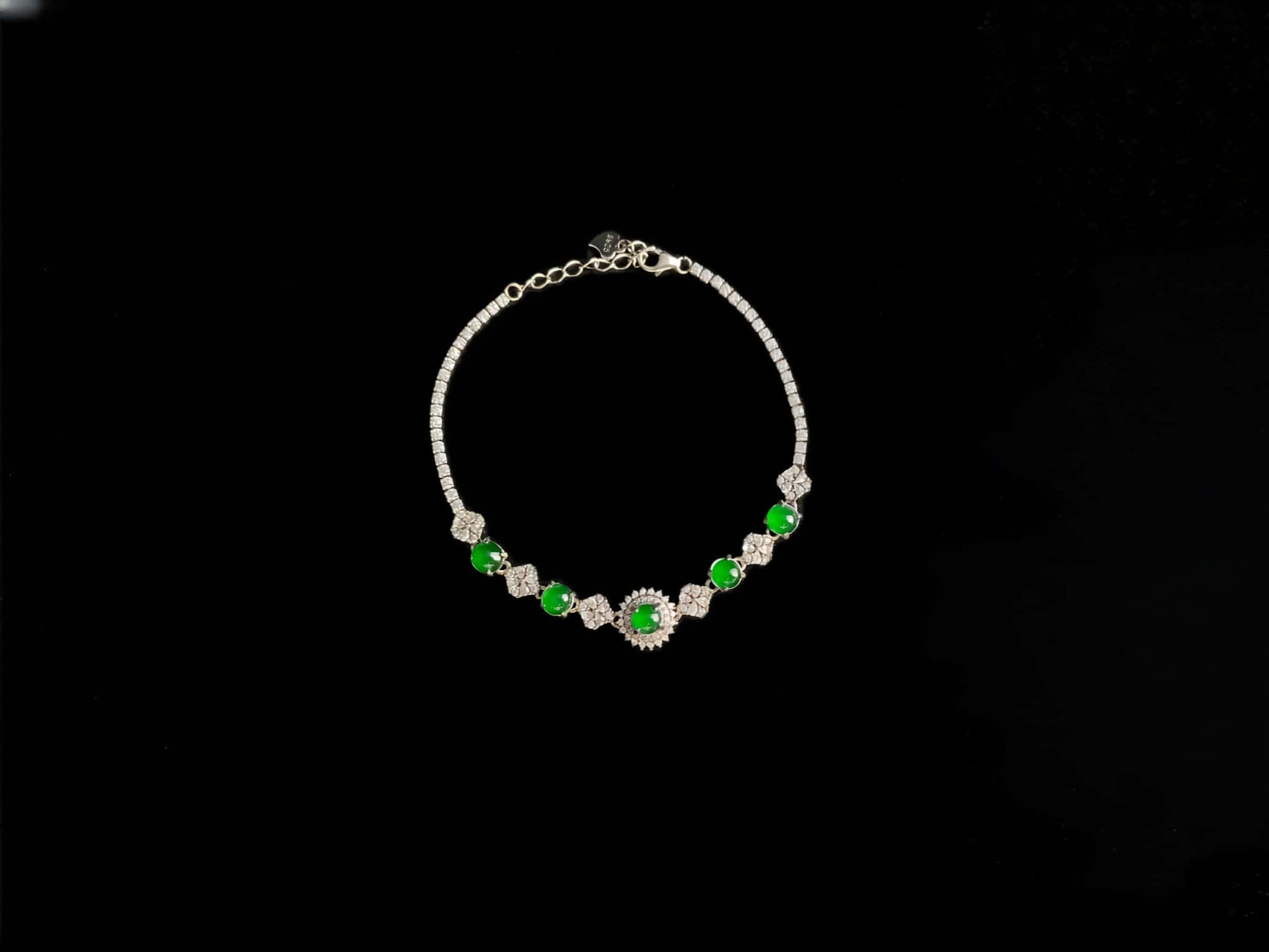 A green sunburst halo jadeite bracelet.