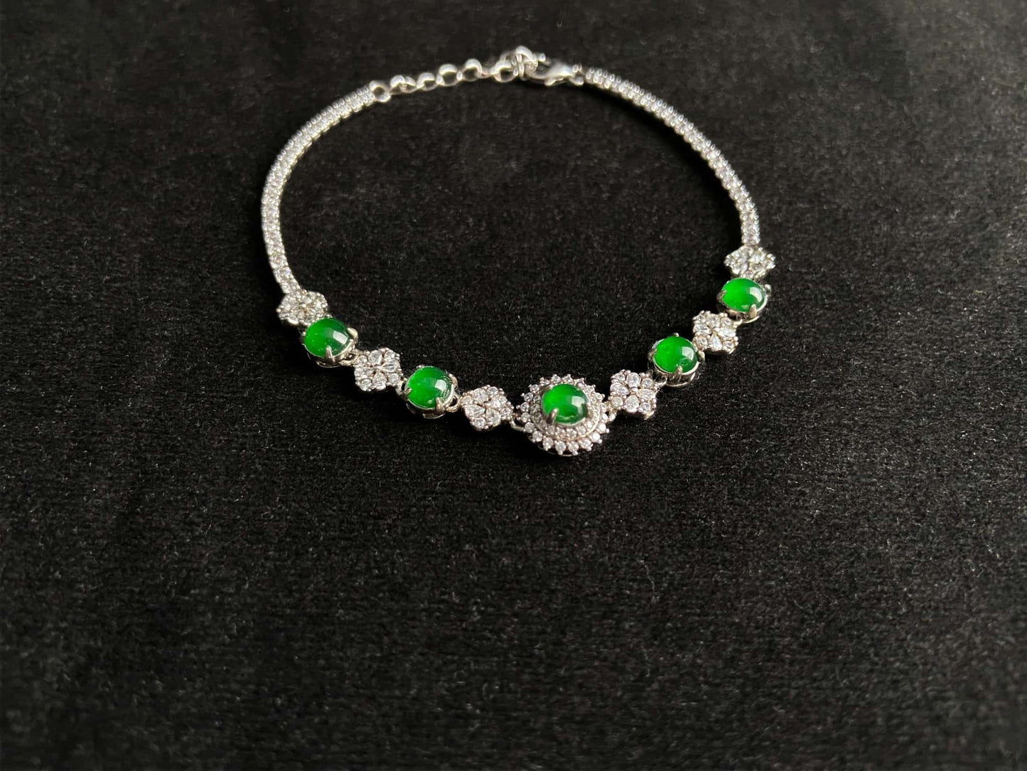A green sunburst halo jadeite bracelet.
