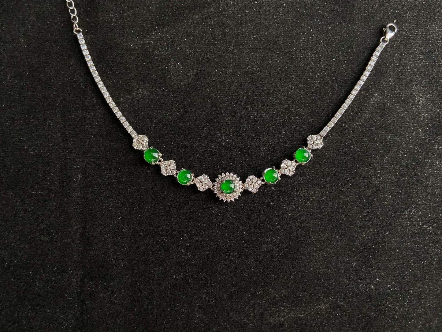 A green sunburst halo jadeite bracelet.