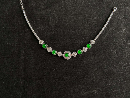A green sunburst halo jadeite bracelet.