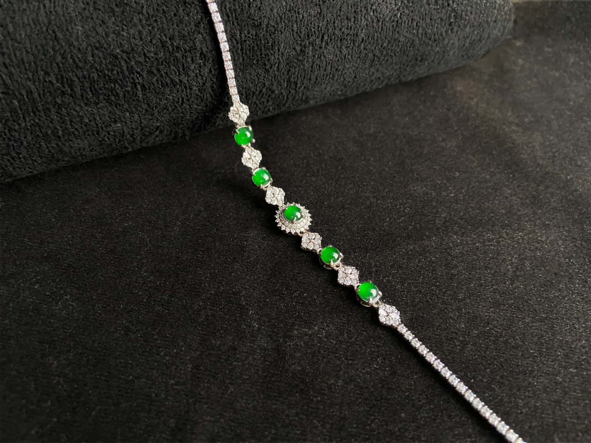 A green sunburst halo jadeite bracelet.