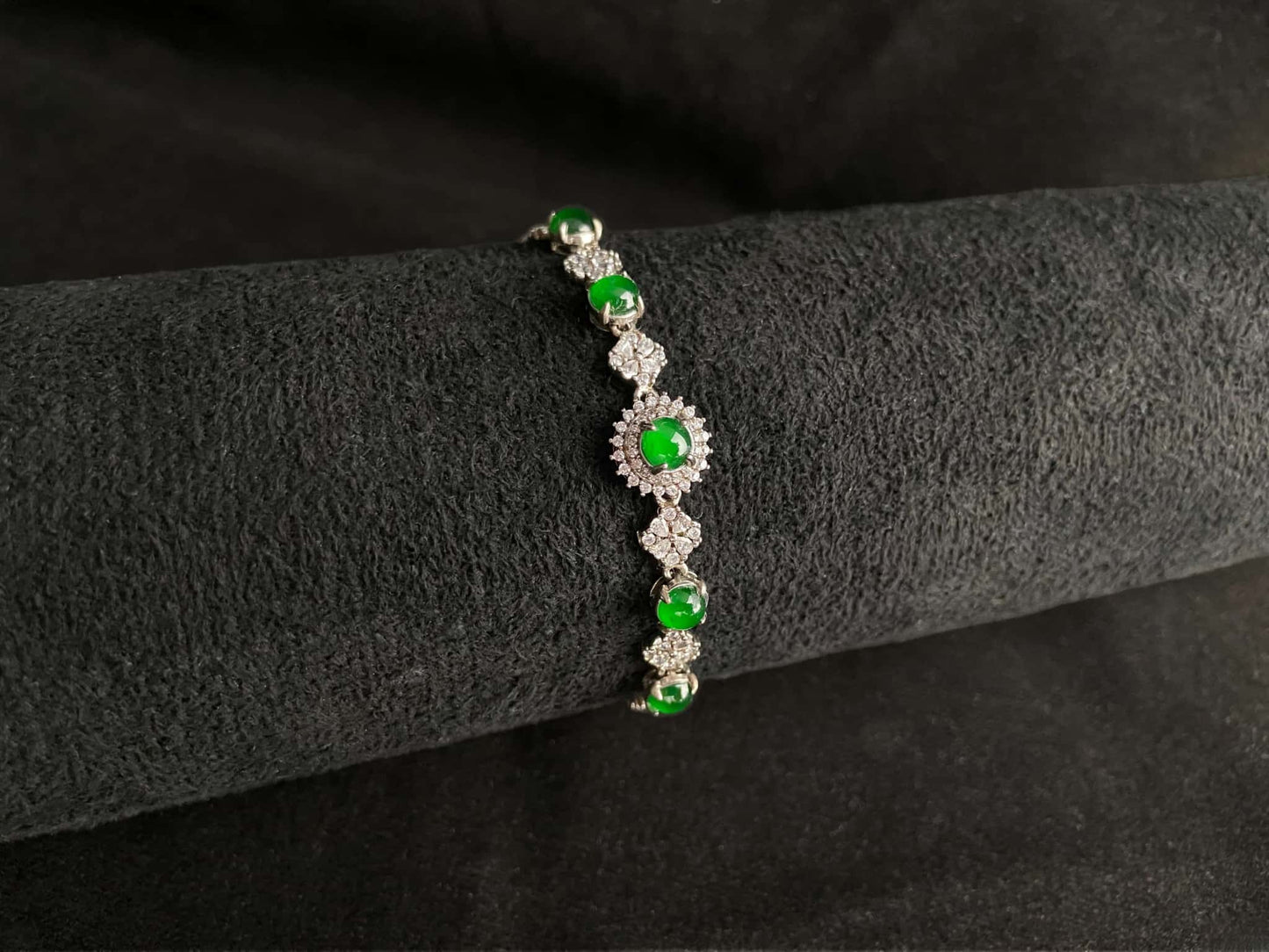 A green sunburst halo jadeite bracelet.