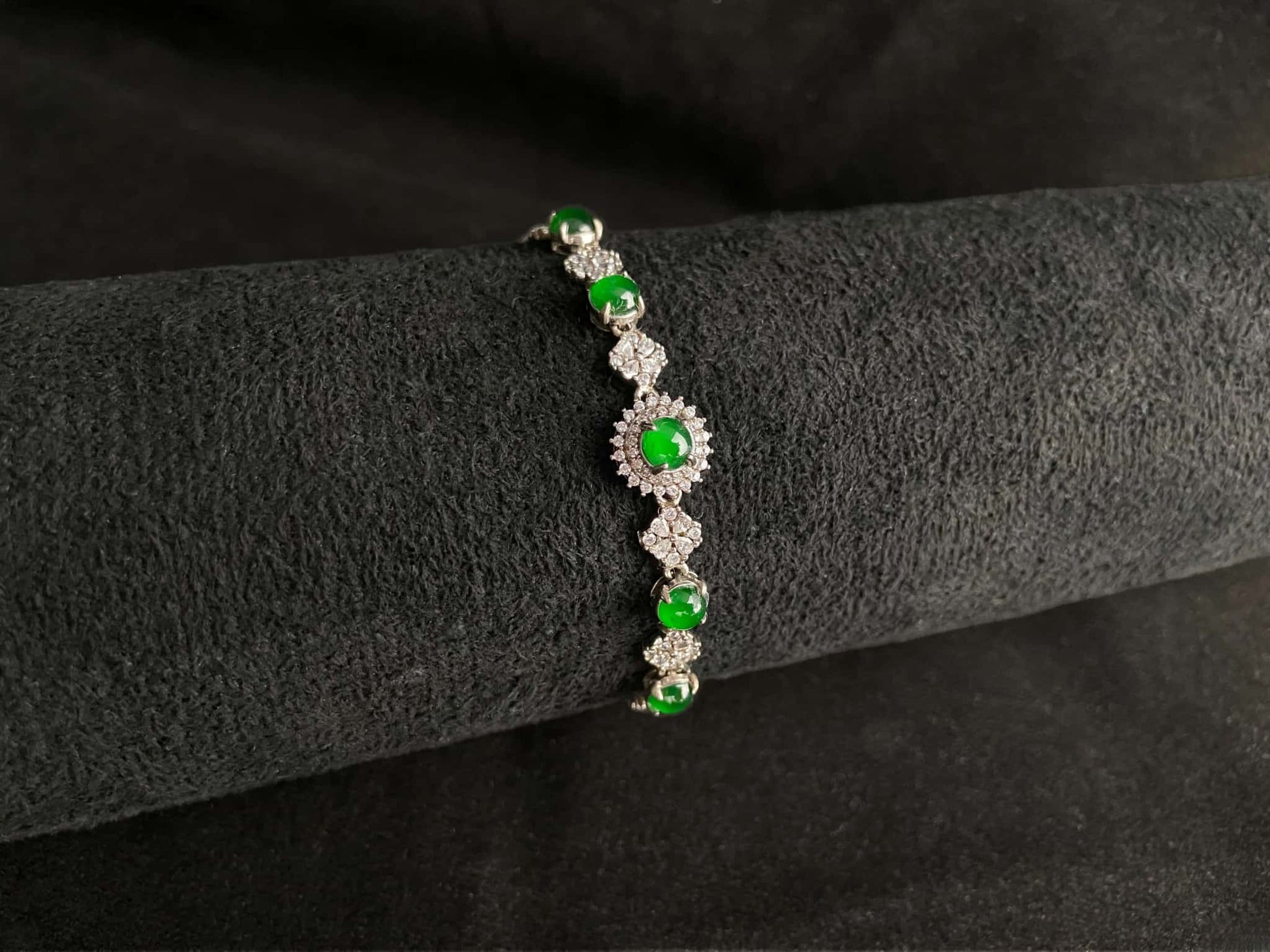 A green sunburst halo jadeite bracelet.