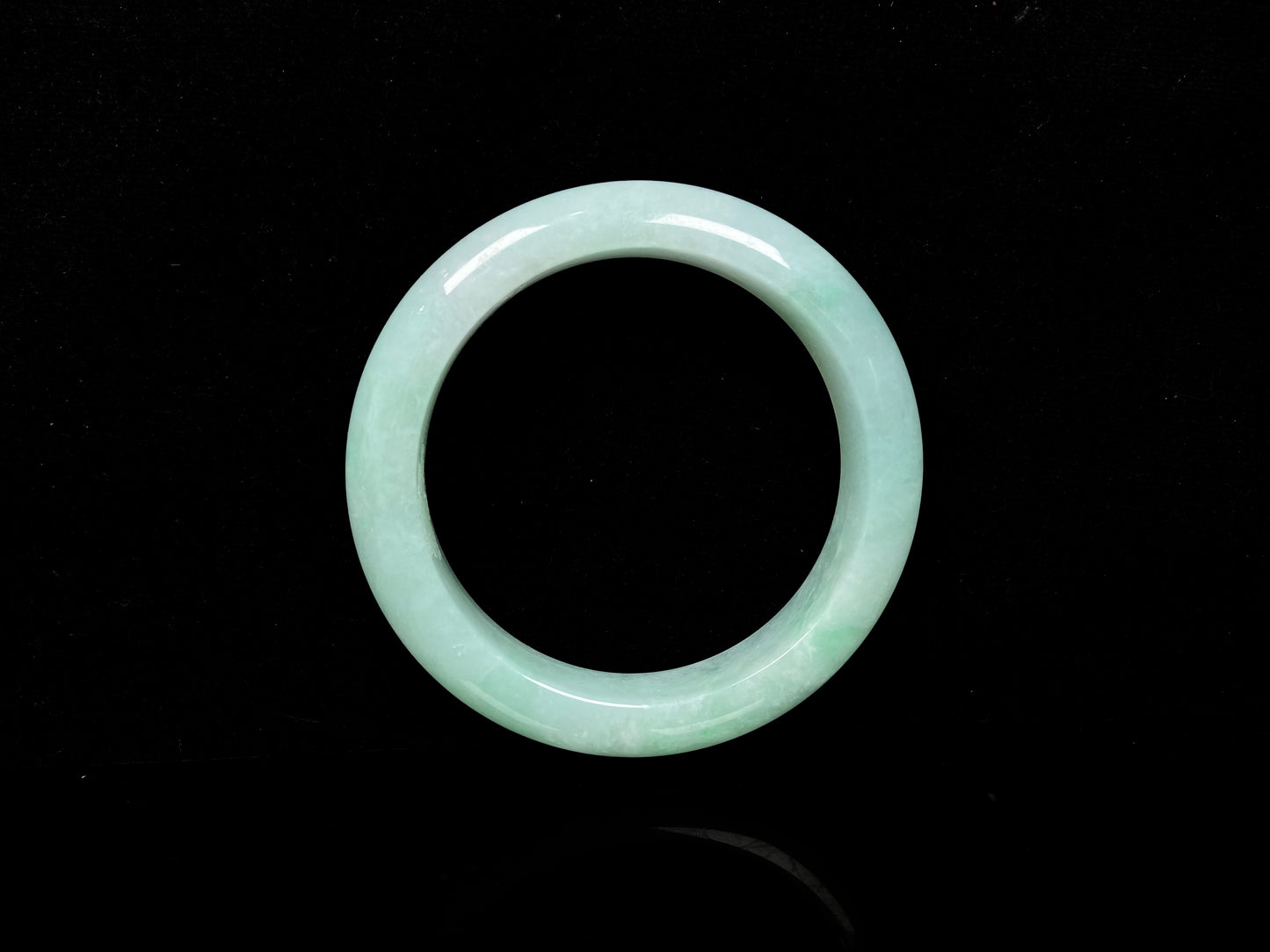 A apple green crisp bloom jadeite bangle.