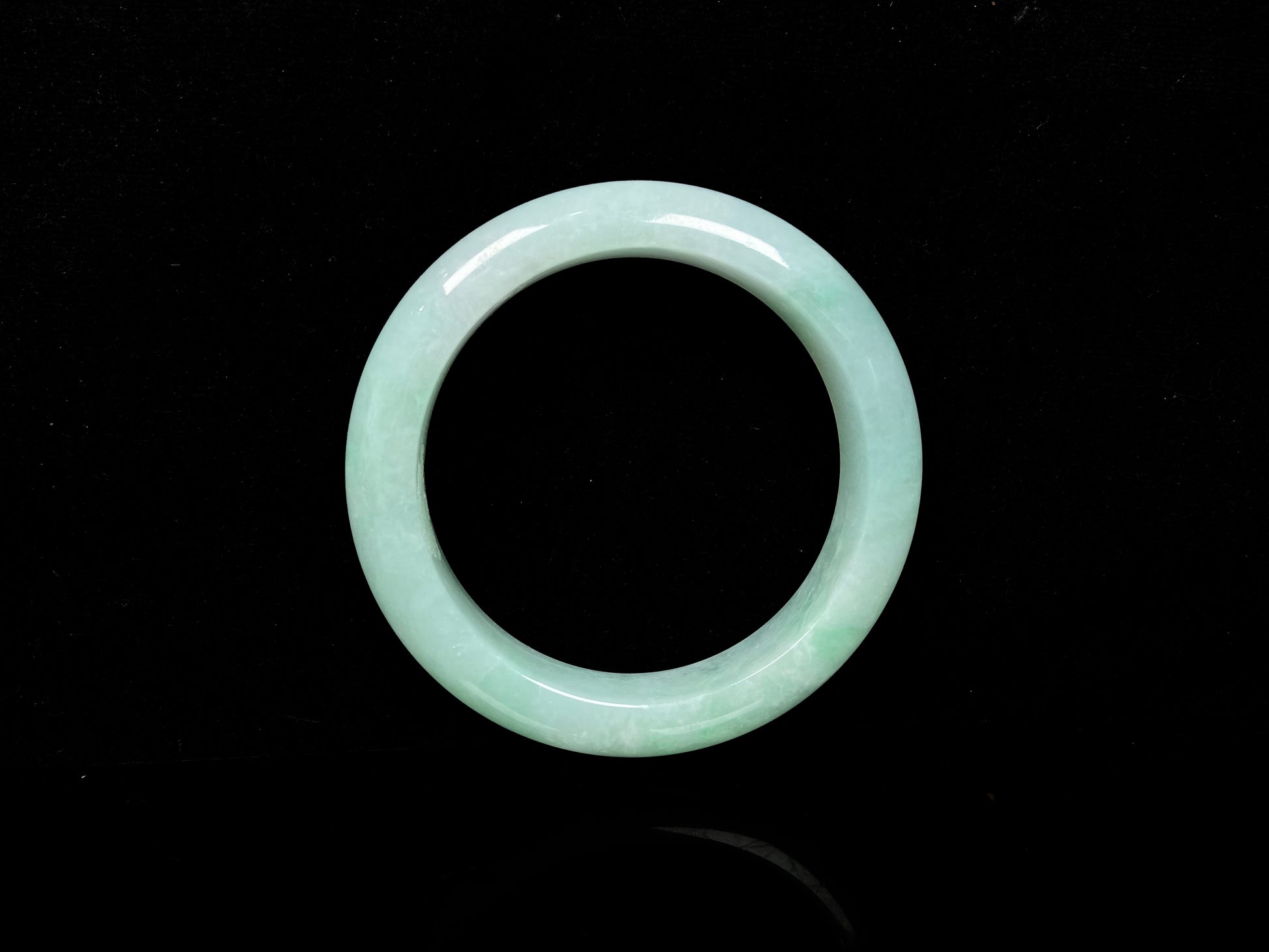 A apple green crisp bloom jadeite bangle.