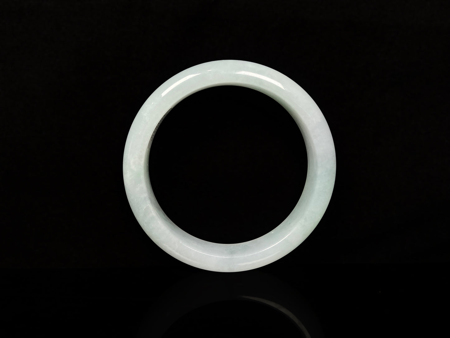 A pale white green mist jadeite bangle.