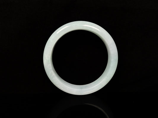 A pale white green mist jadeite bangle.