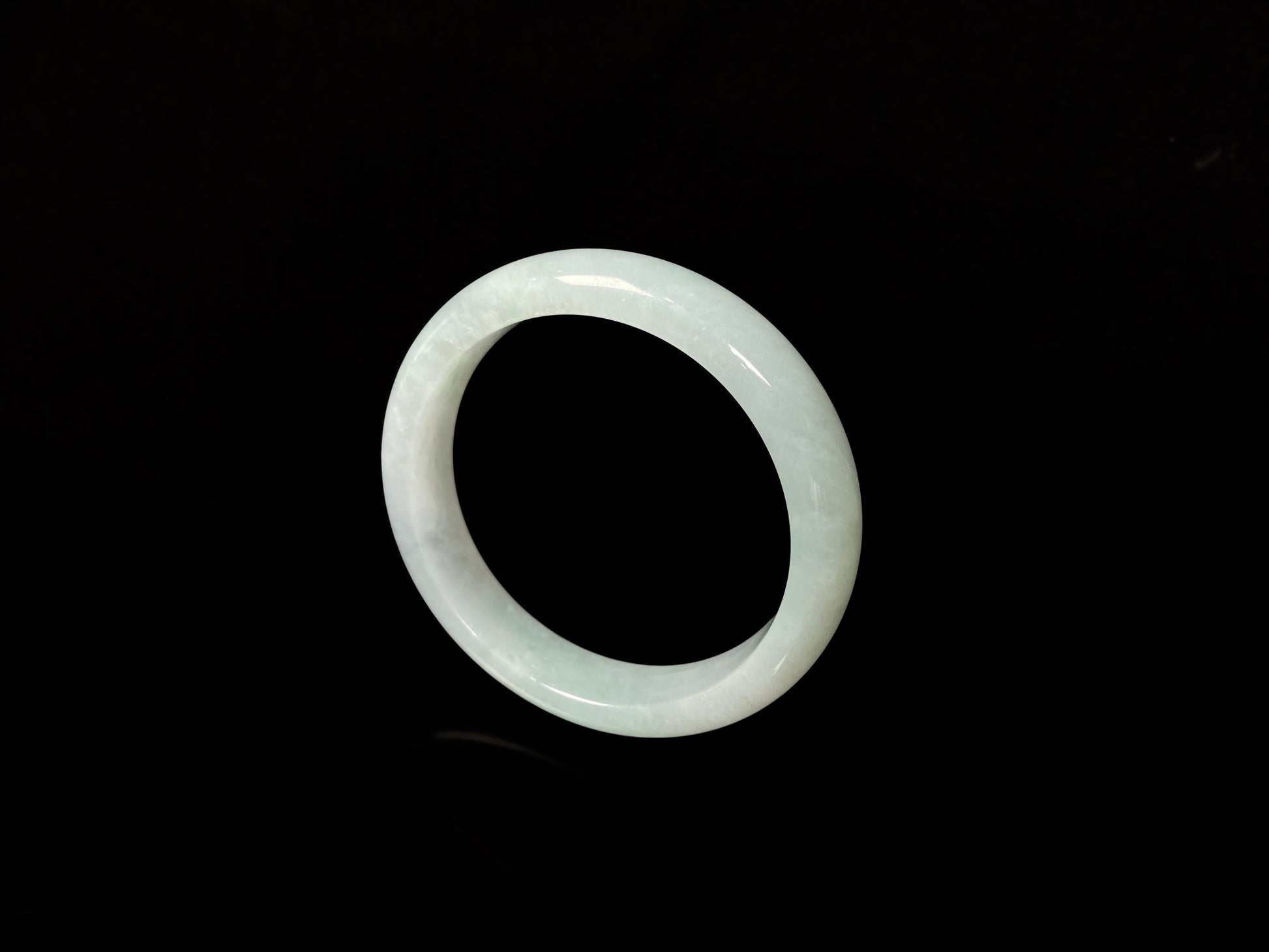 A pale white green mist jadeite bangle.