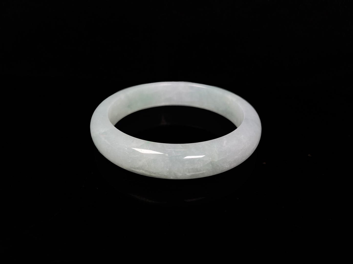 A pale white green mist jadeite bangle.