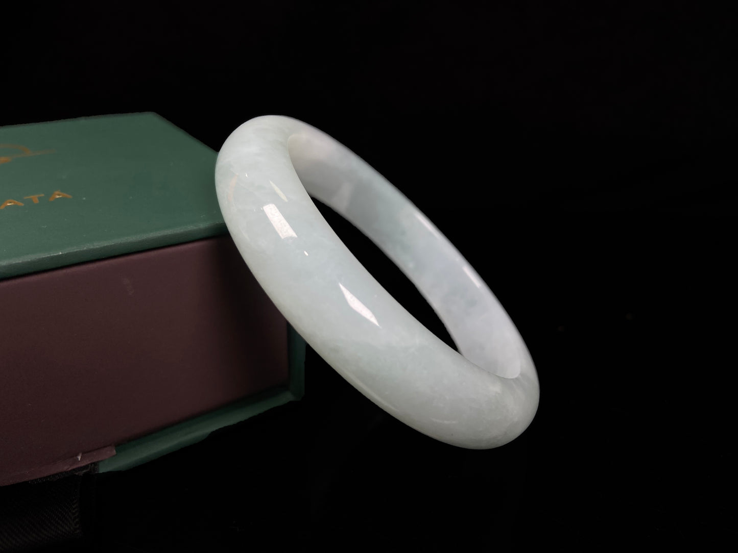 A pale white green mist jadeite bangle.
