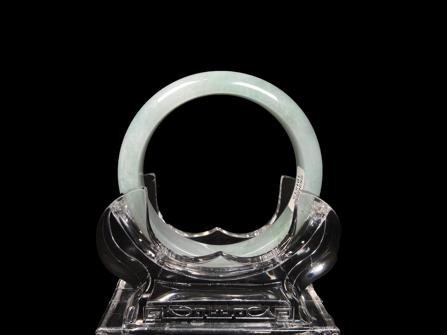A pale white green mist jadeite bangle.