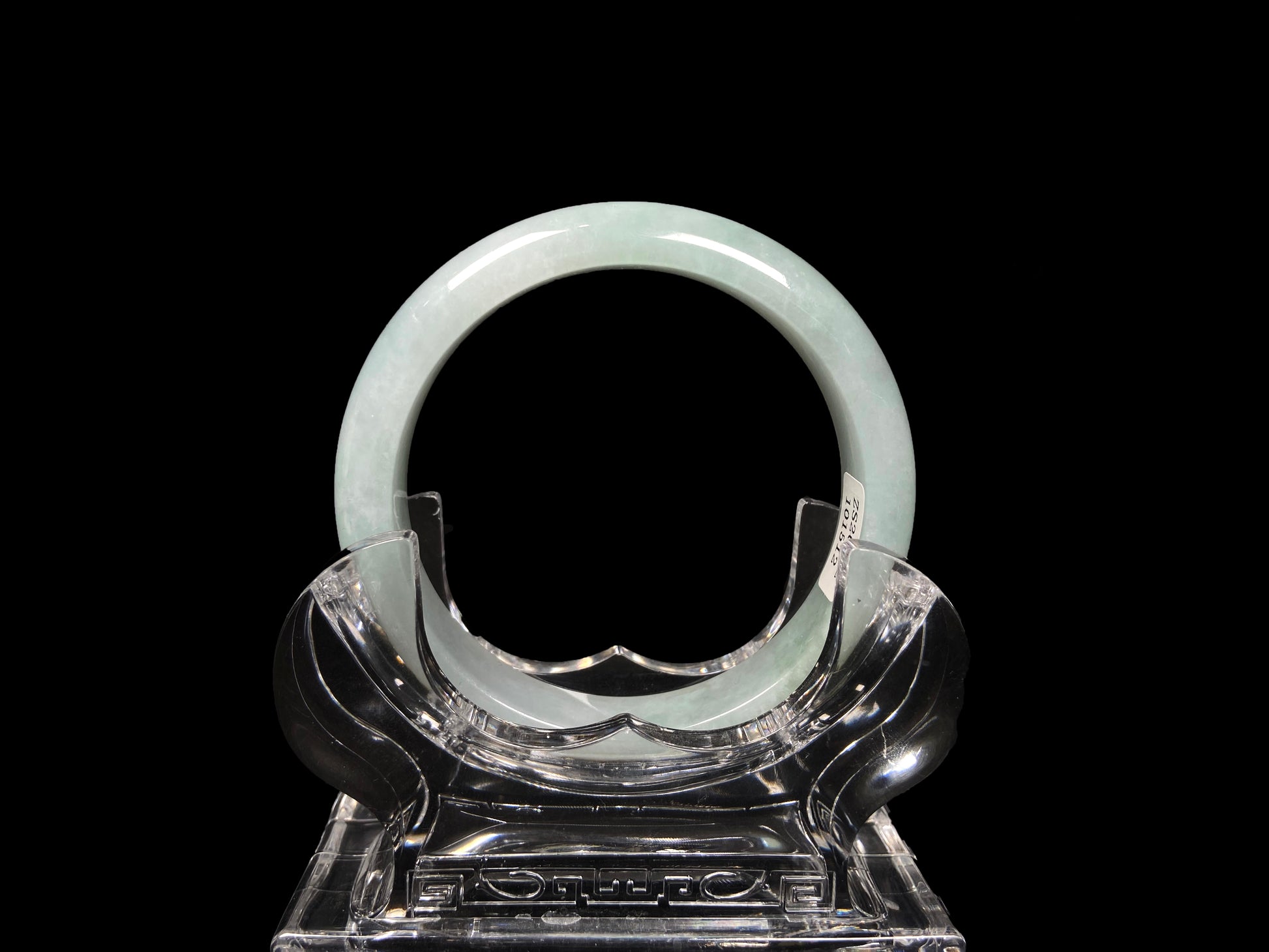 A pale white green mist jadeite bangle.