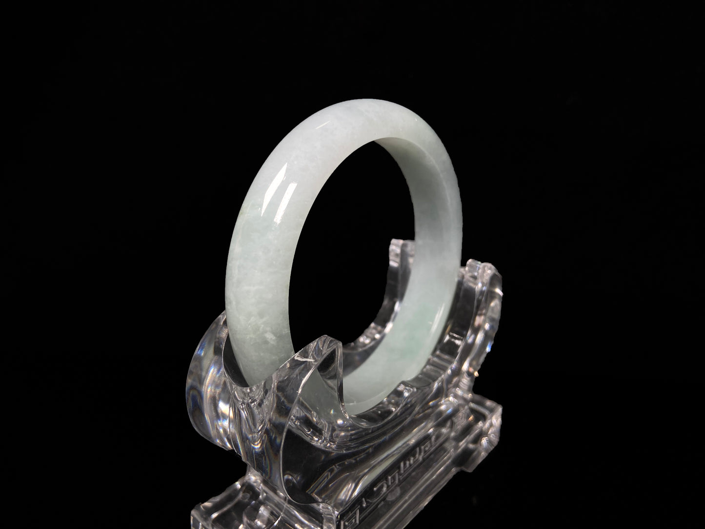 A pale white green mist jadeite bangle.