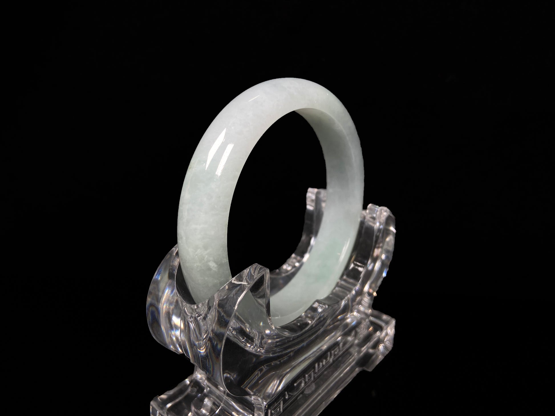 A pale white green mist jadeite bangle.