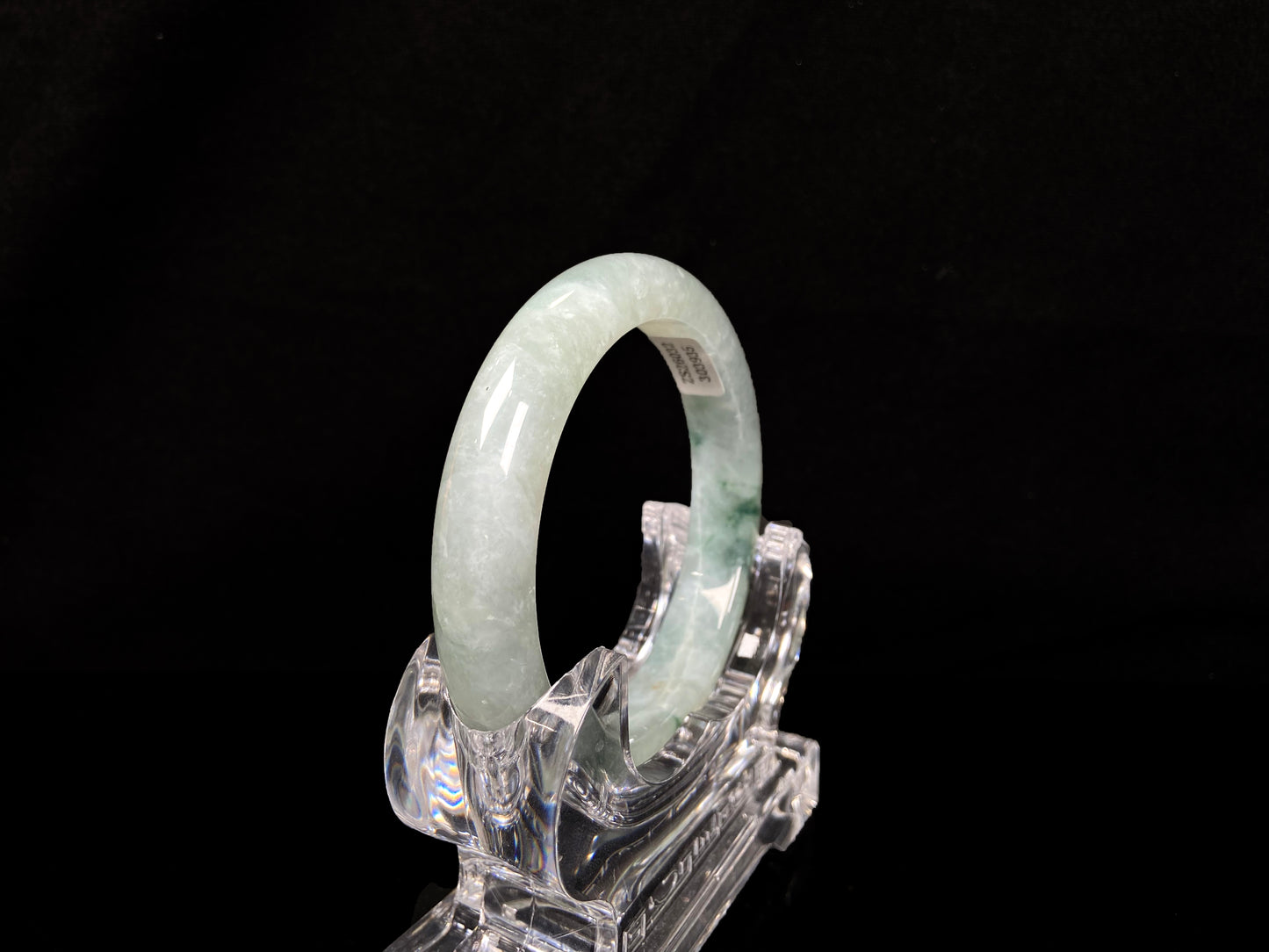 A misty cloud floral green jadeite bangle.