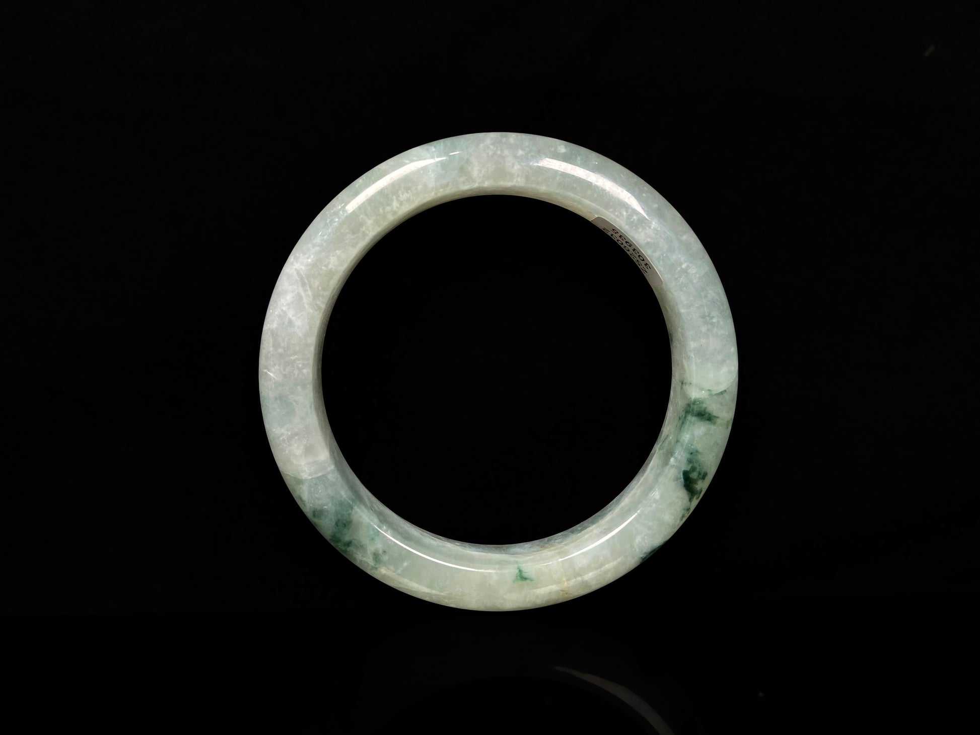 A misty cloud floral green jadeite bangle.