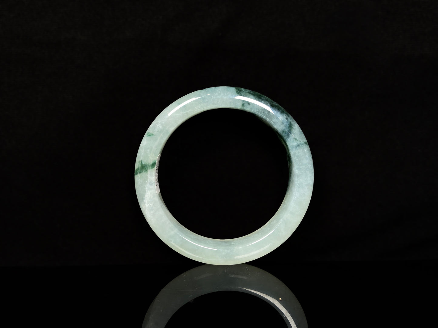 A moss green icy bloom jadeite bangle.