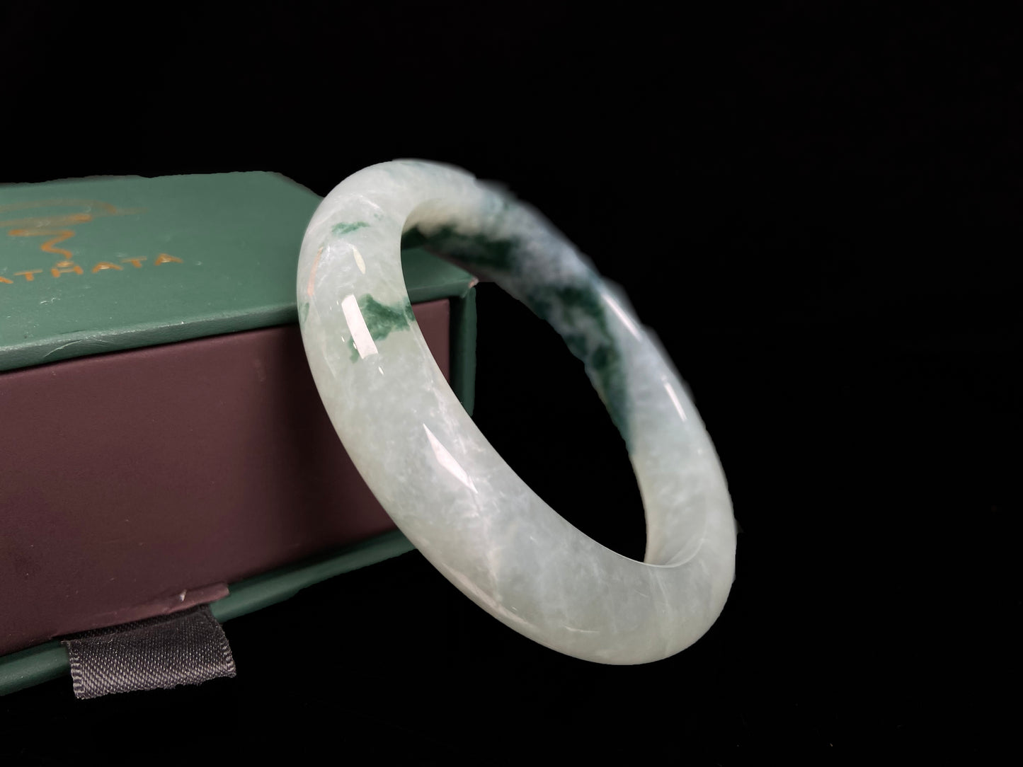 A moss green icy bloom jadeite bangle.
