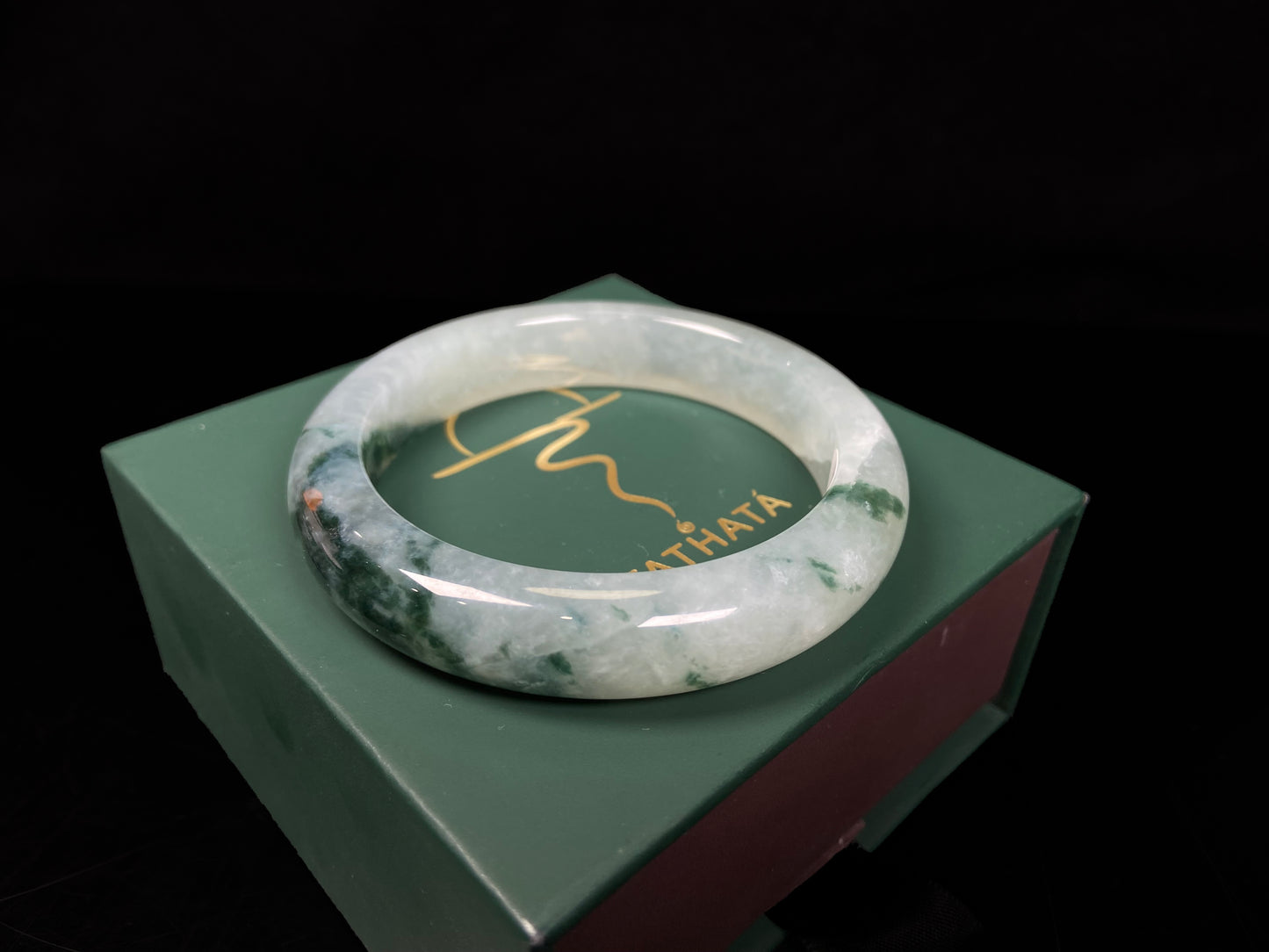 A moss green icy bloom jadeite bangle.