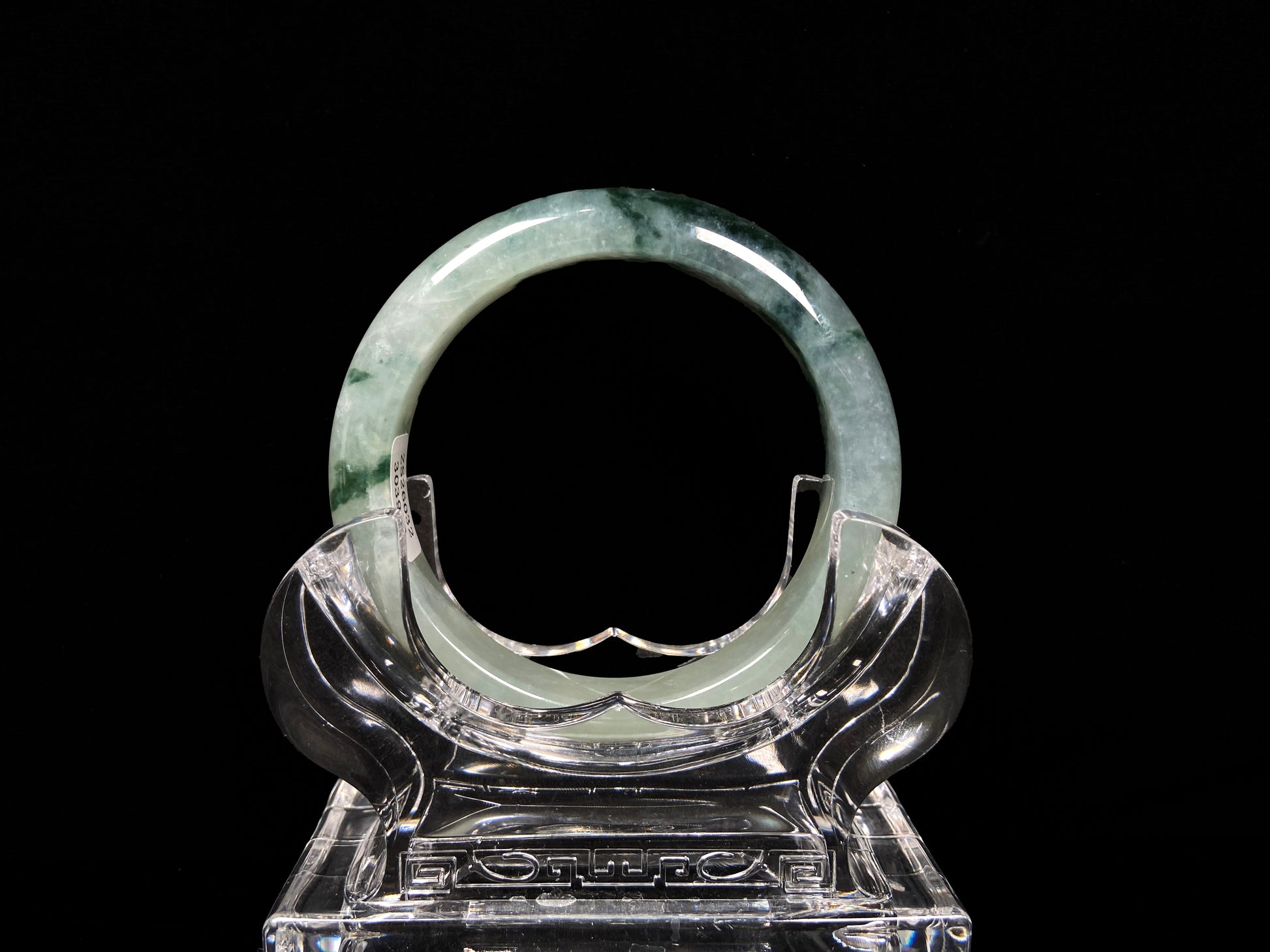 A moss green icy bloom jadeite bangle.