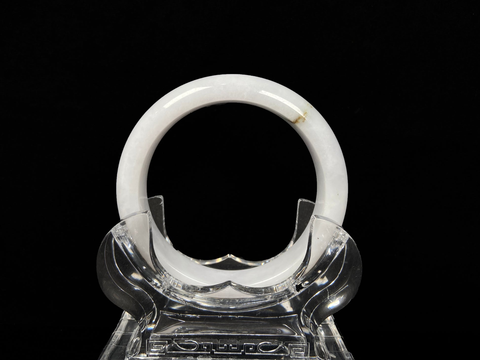 A milky white golden line jadeite bangle.