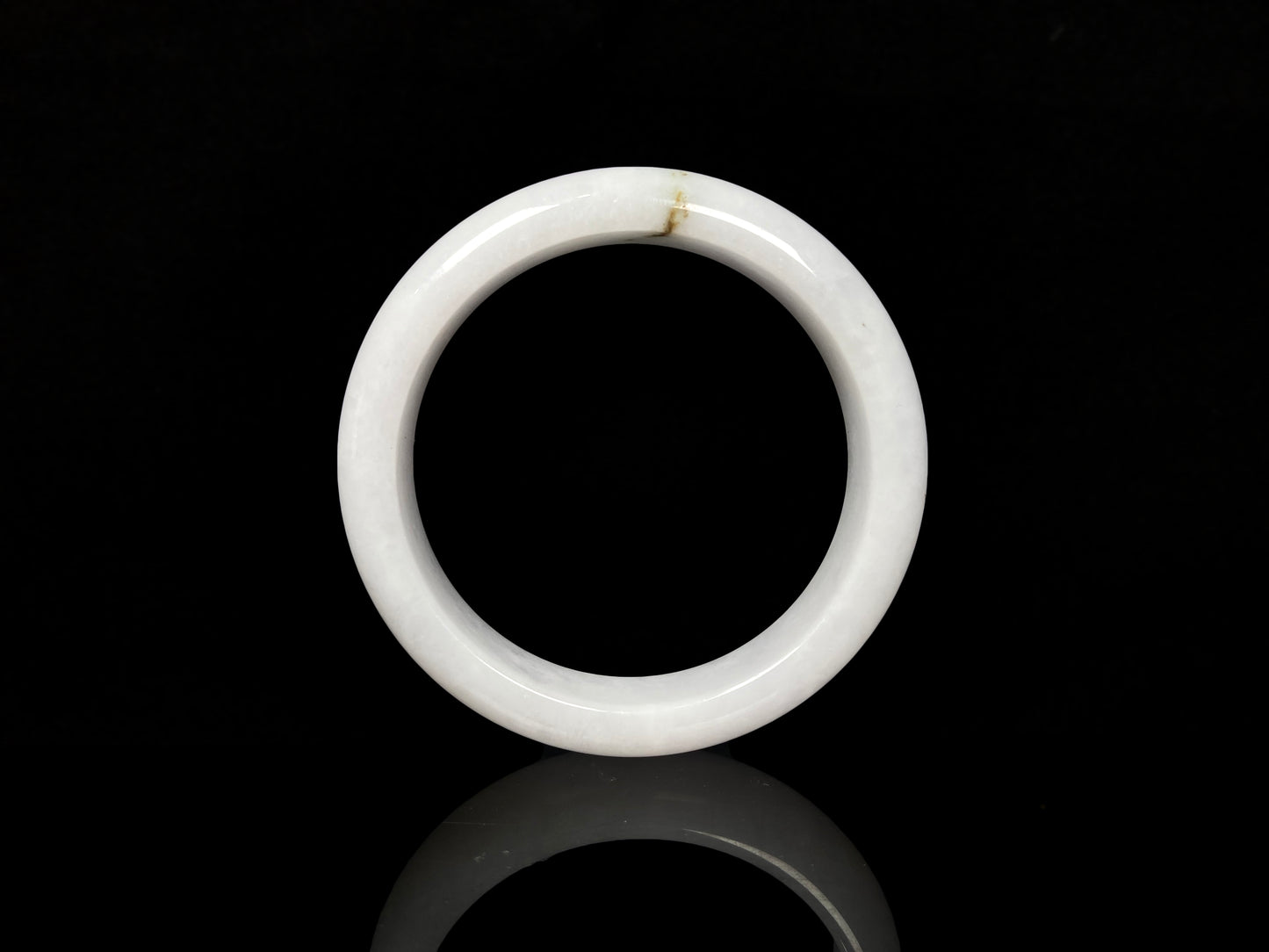 A milky white golden line jadeite bangle.
