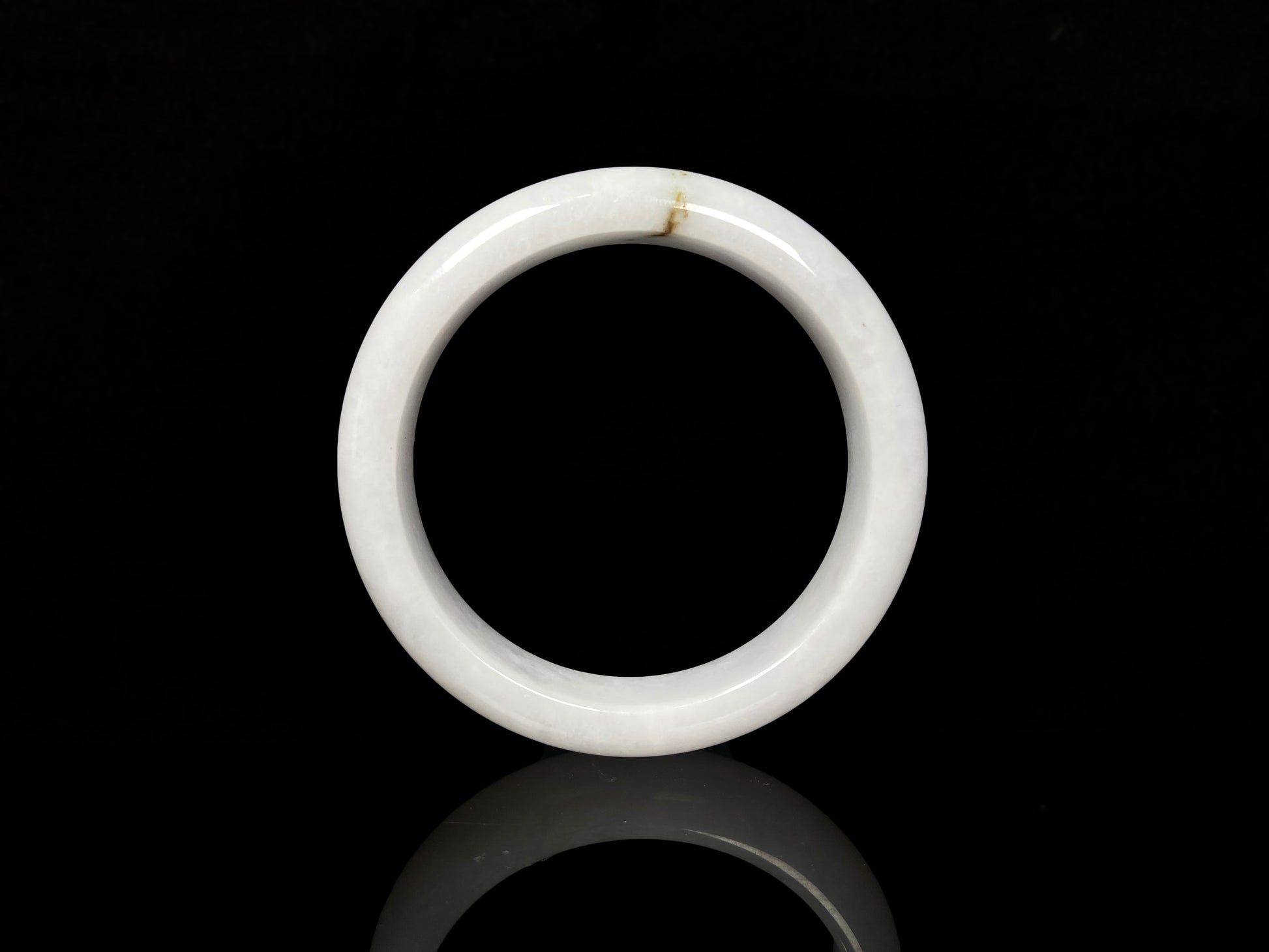 A milky white golden line jadeite bangle.