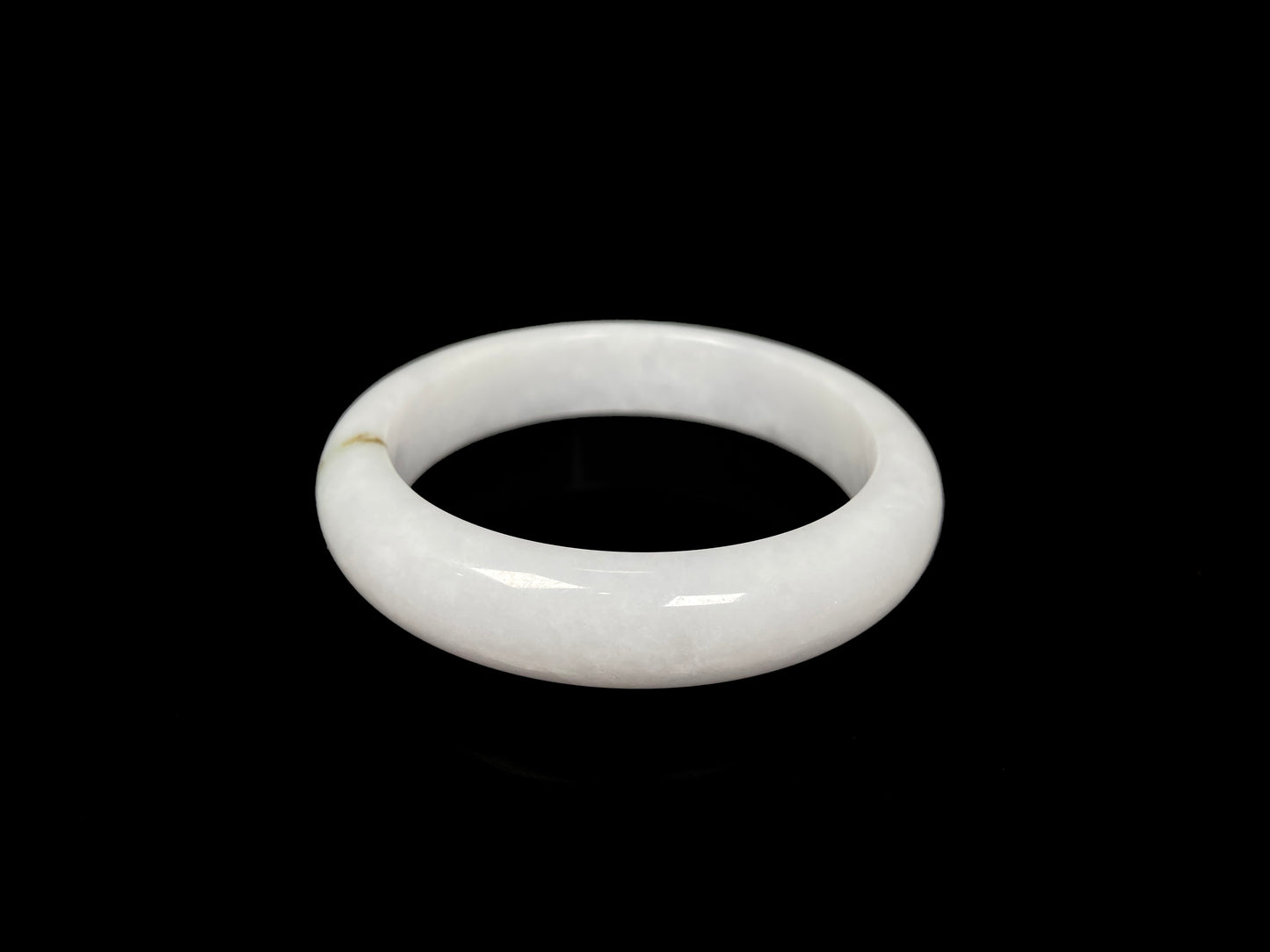 A milky white golden line jadeite bangle.