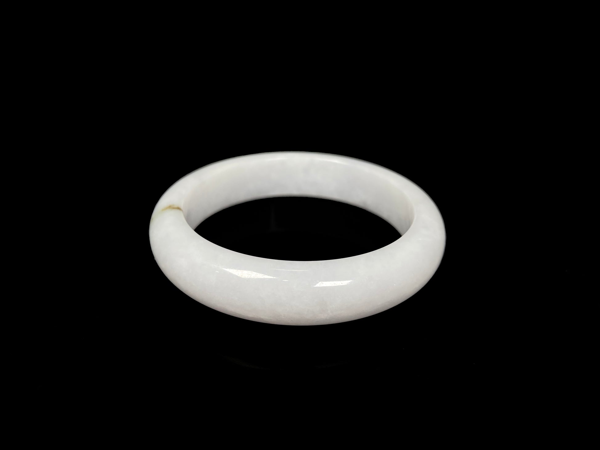 A milky white golden line jadeite bangle.