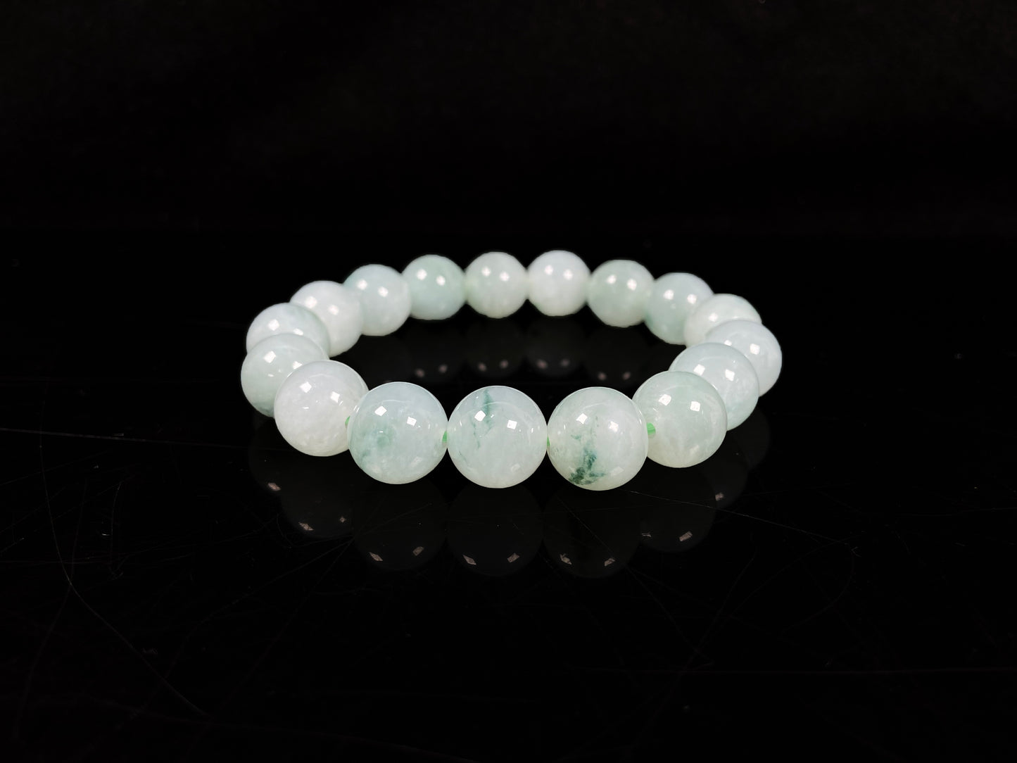 A translucent green with forest fleck  jadeite beads bracelet.