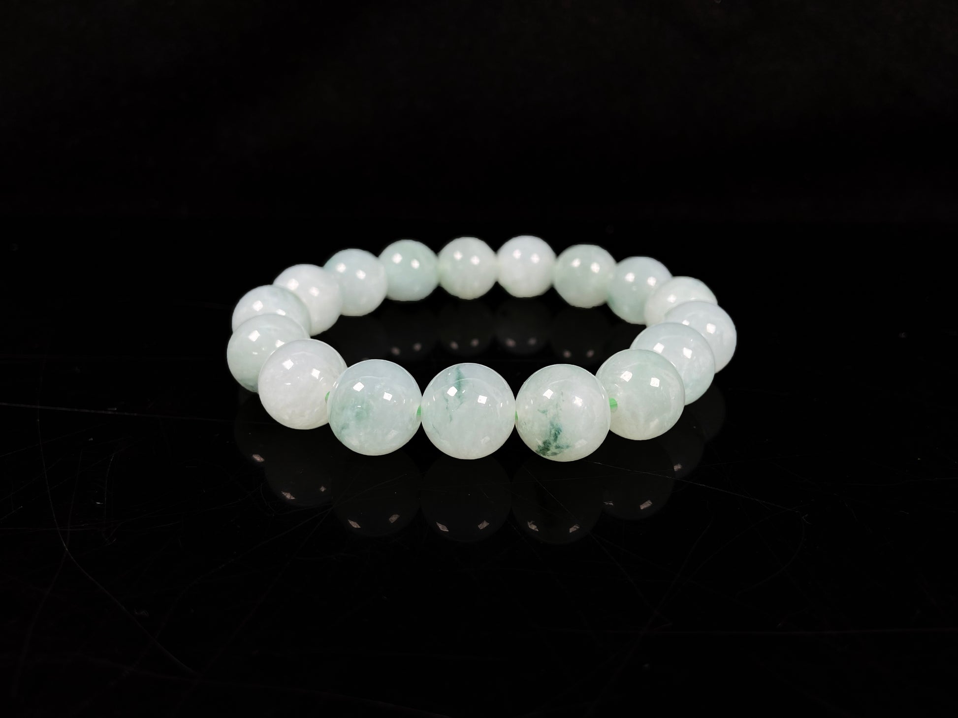 A translucent green with forest fleck  jadeite beads bracelet.