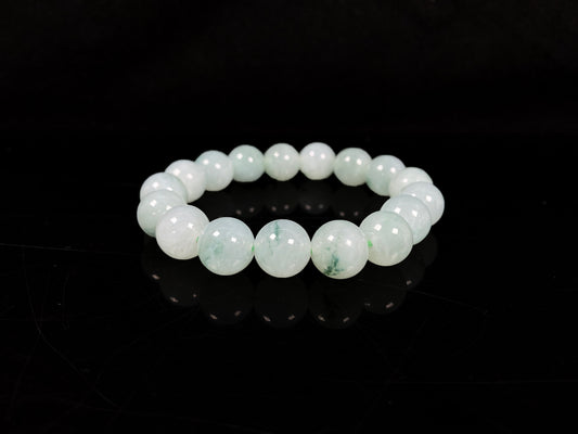 A translucent green with forest fleck  jadeite beads bracelet.