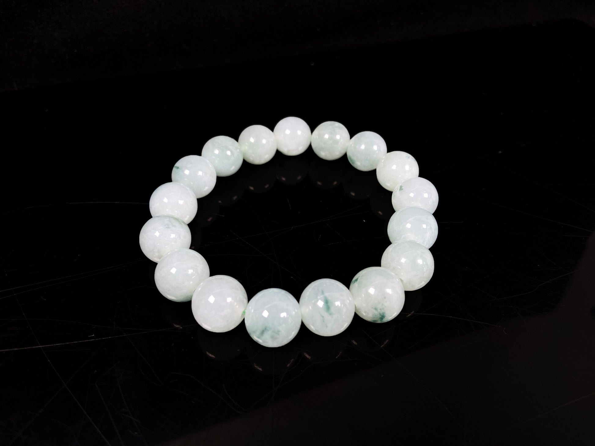 A translucent green with forest fleck  jadeite beads bracelet.