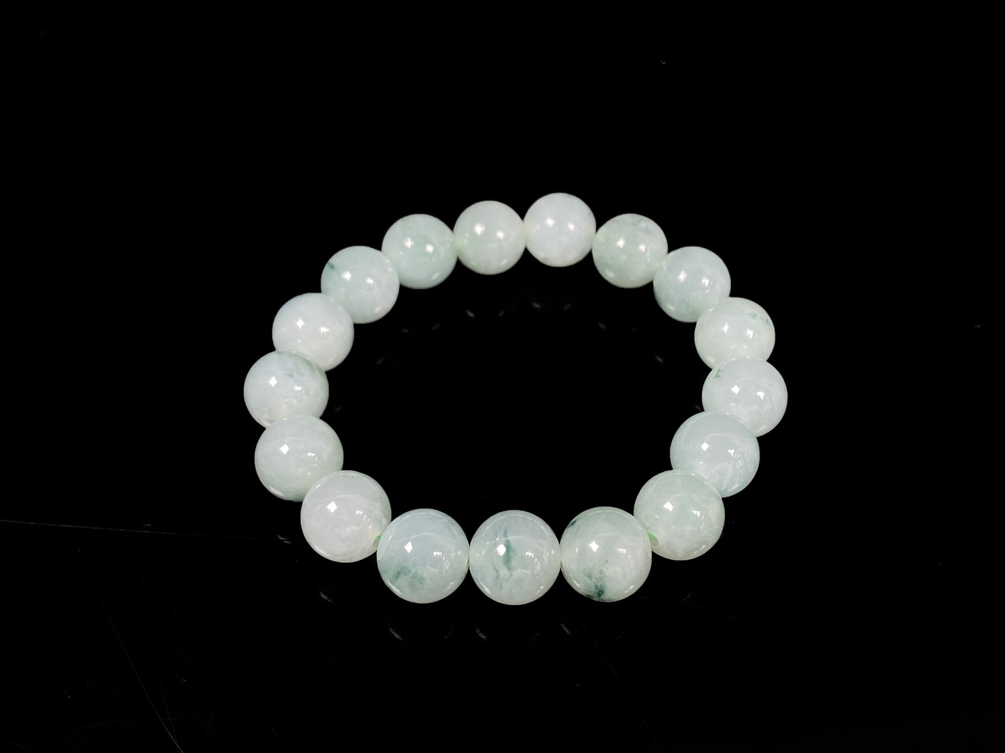 A translucent green with forest fleck  jadeite beads bracelet.