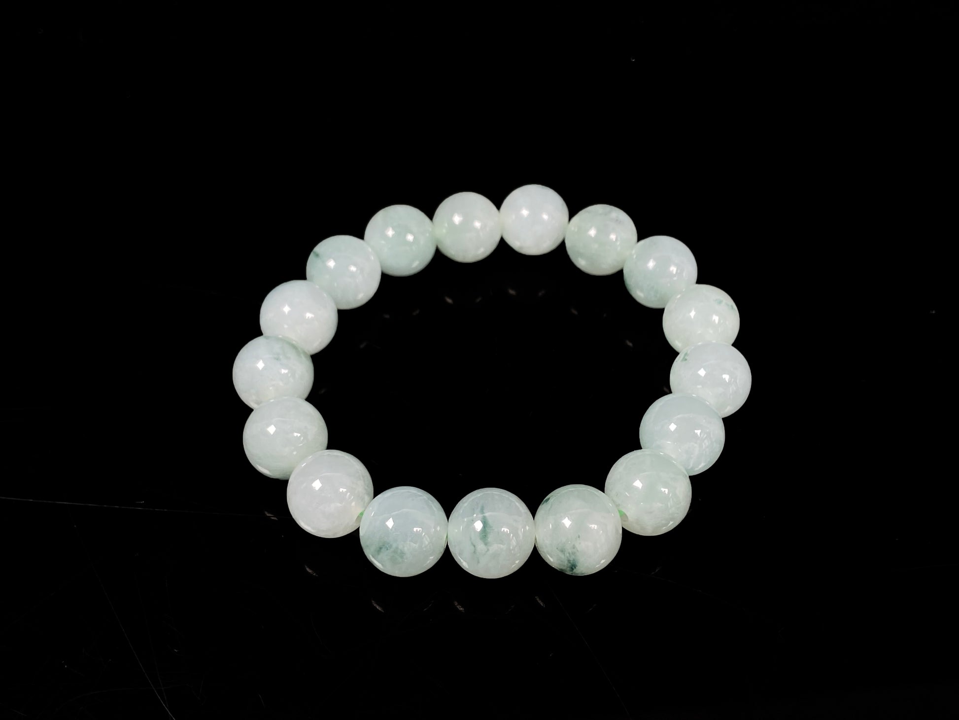 A translucent green with forest fleck  jadeite beads bracelet.