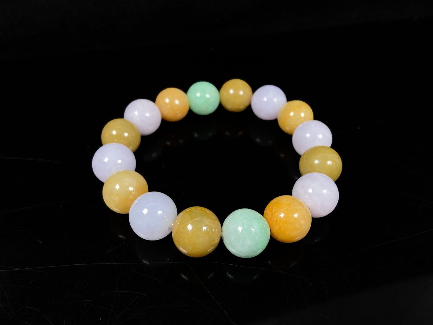 A yellow green purple jadeite beads bracelet.