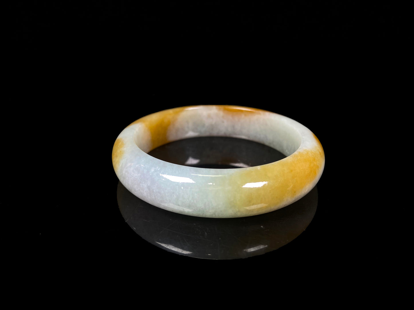 A honeyed frost jadeite bangle.