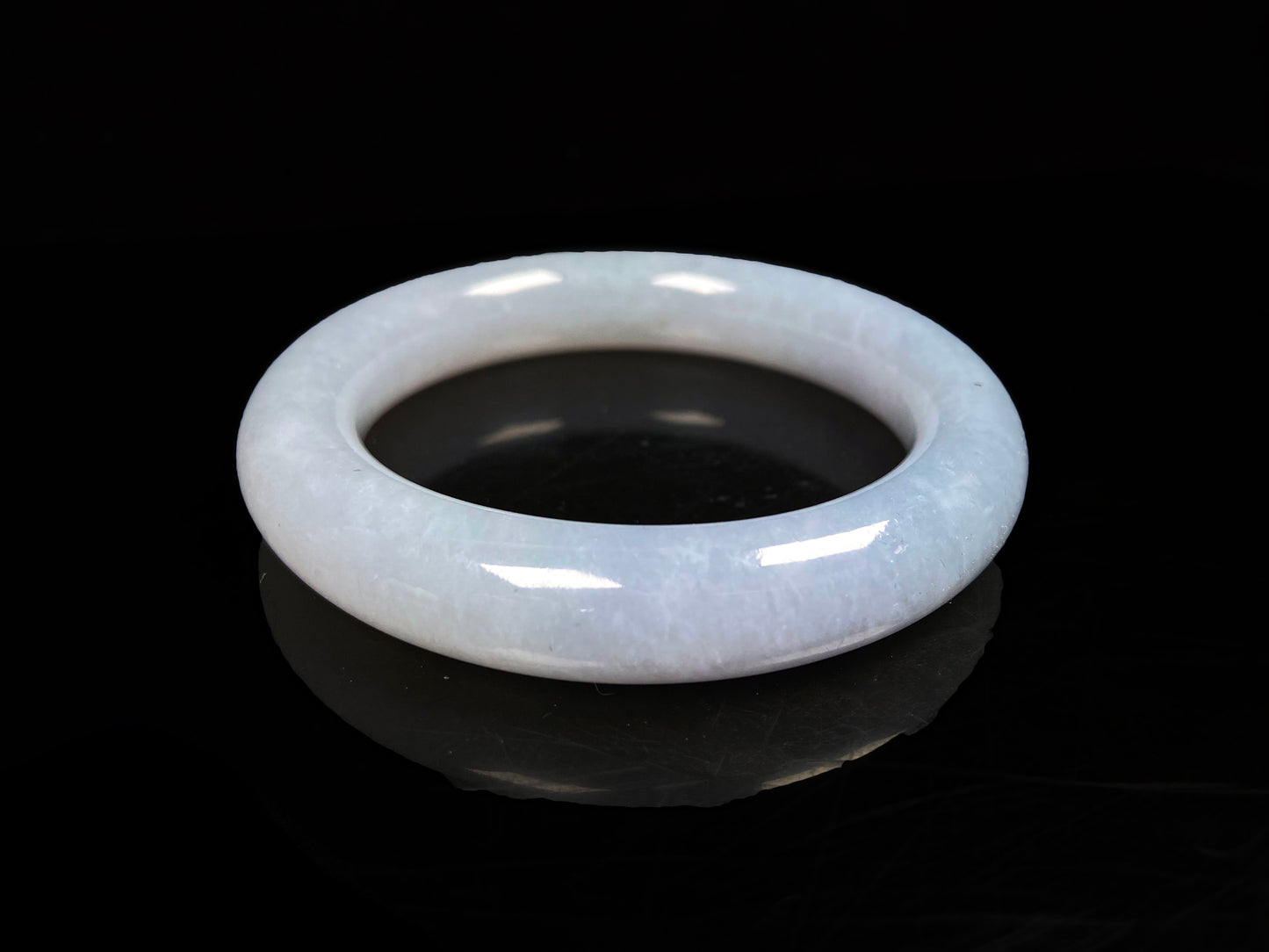 A moonlit white with pale blue jadeite bangle.