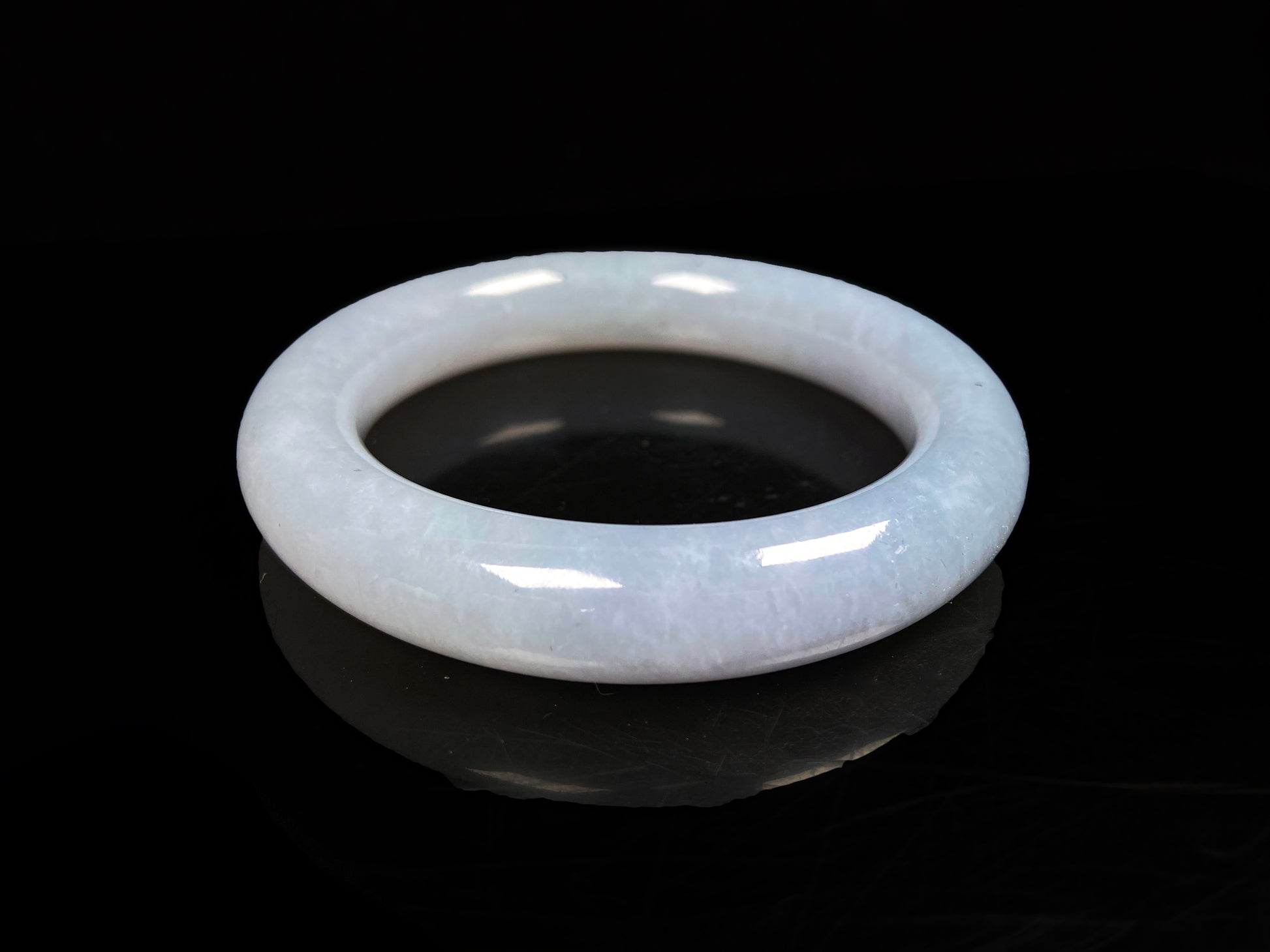 A moonlit white with pale blue jadeite bangle.