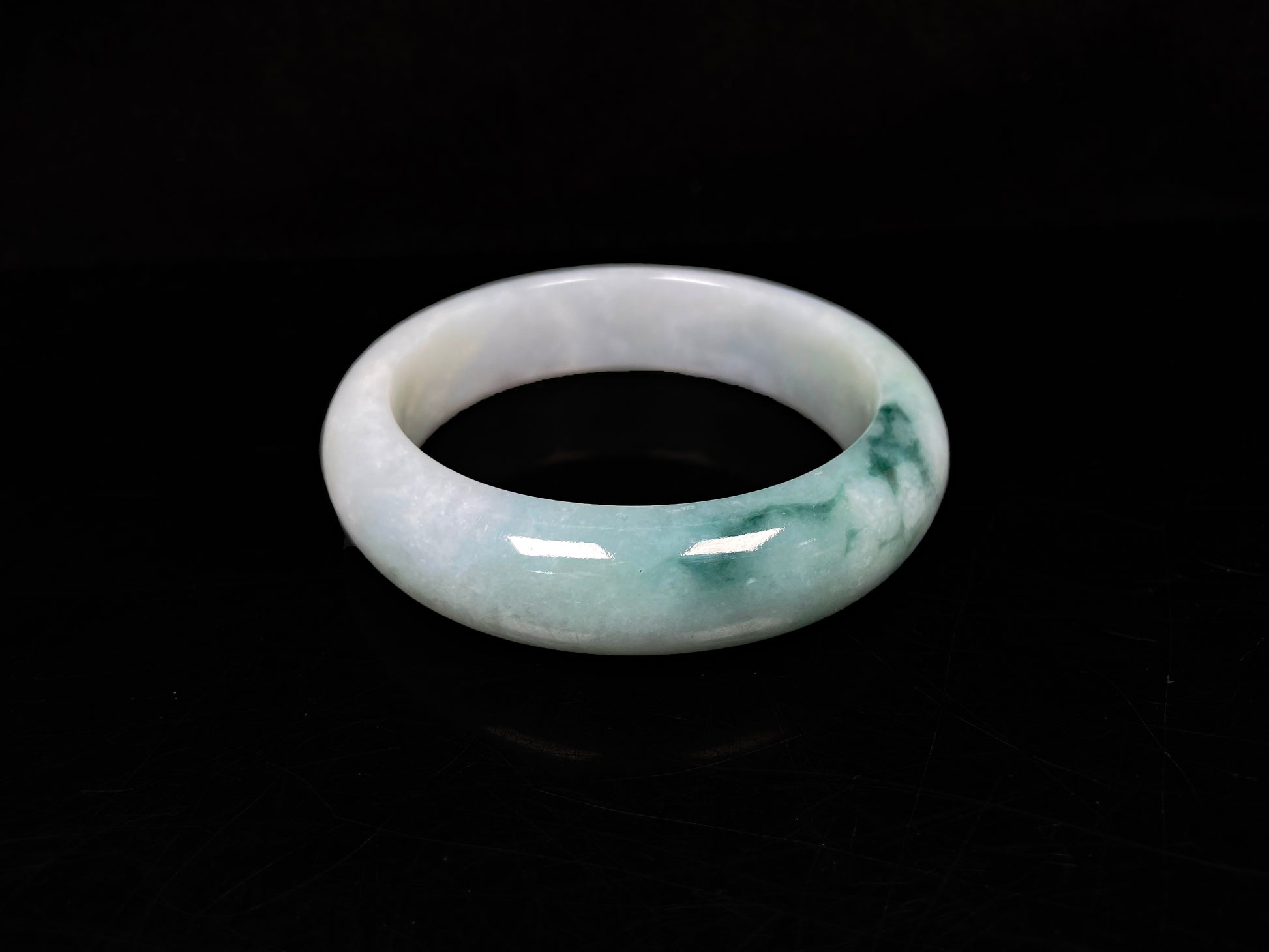 A blue green hues jadeite bangle.