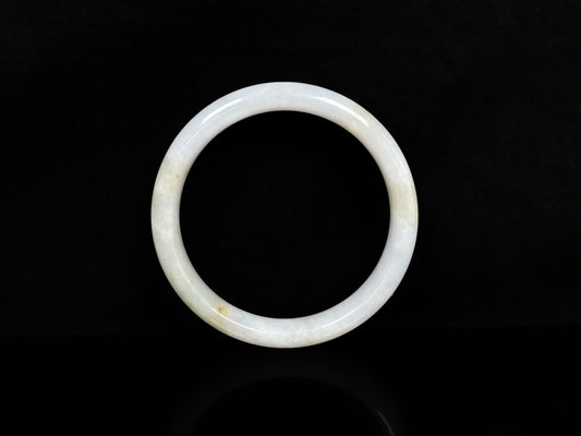 A creamy white with pale yellow  jadeite bangle.