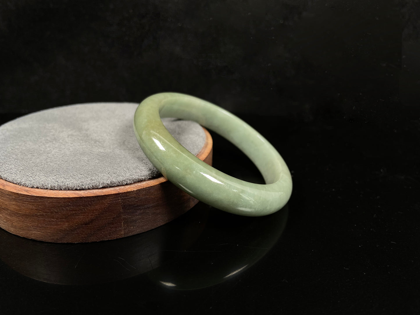 A light green base with warm golden hues jadeite bangle.
