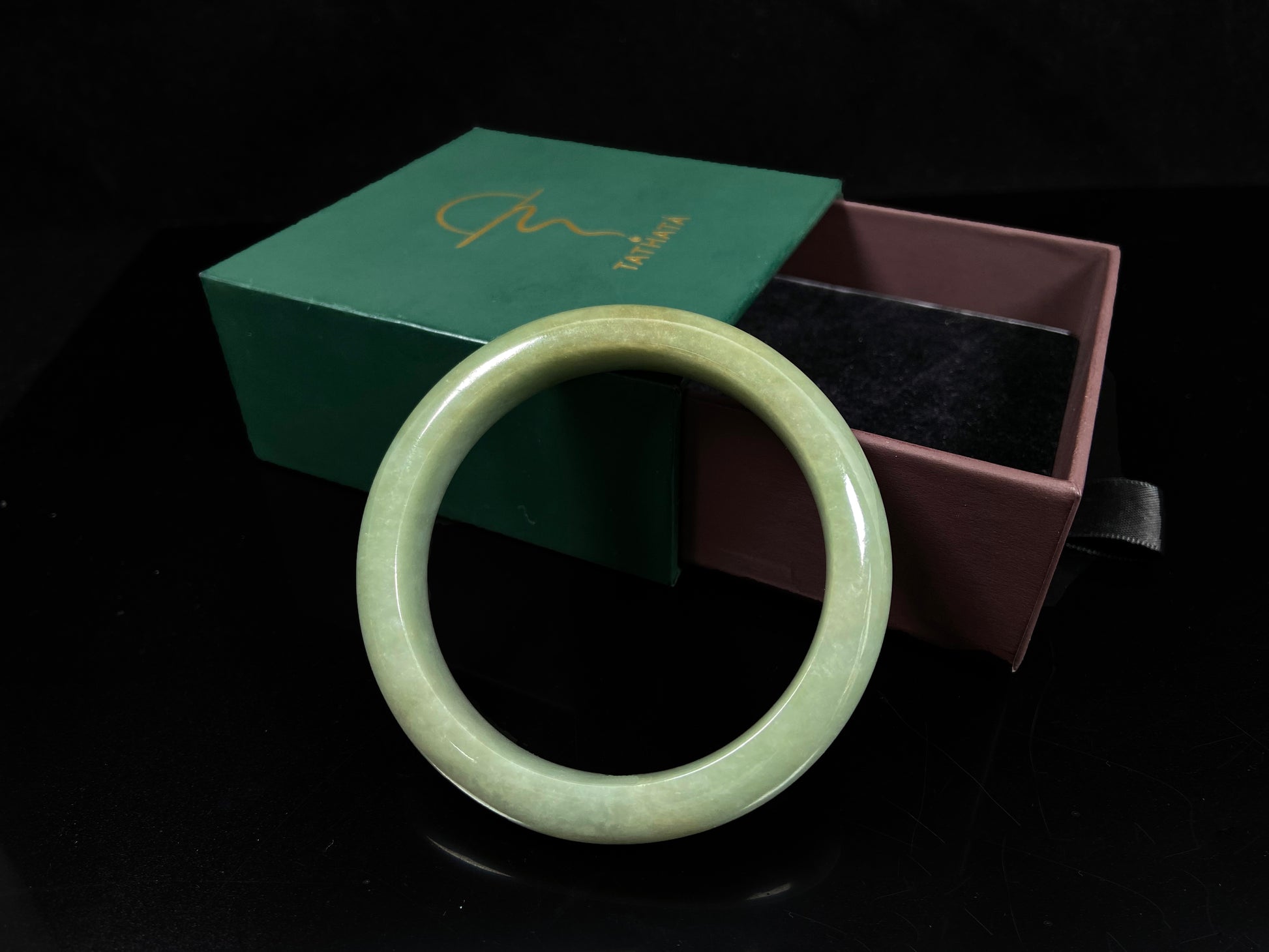 A light green base with warm golden hues jadeite bangle.