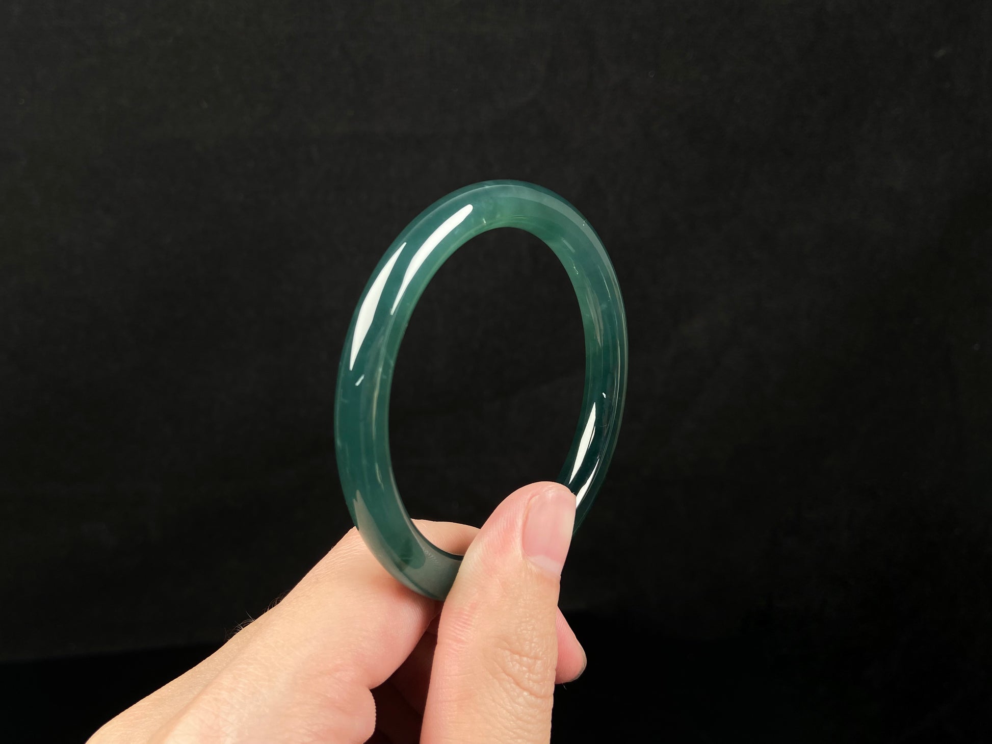 A sleek deep aqua green jadeite bangle.