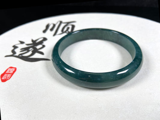 A soft deep blue-green jadeite  bangle.
