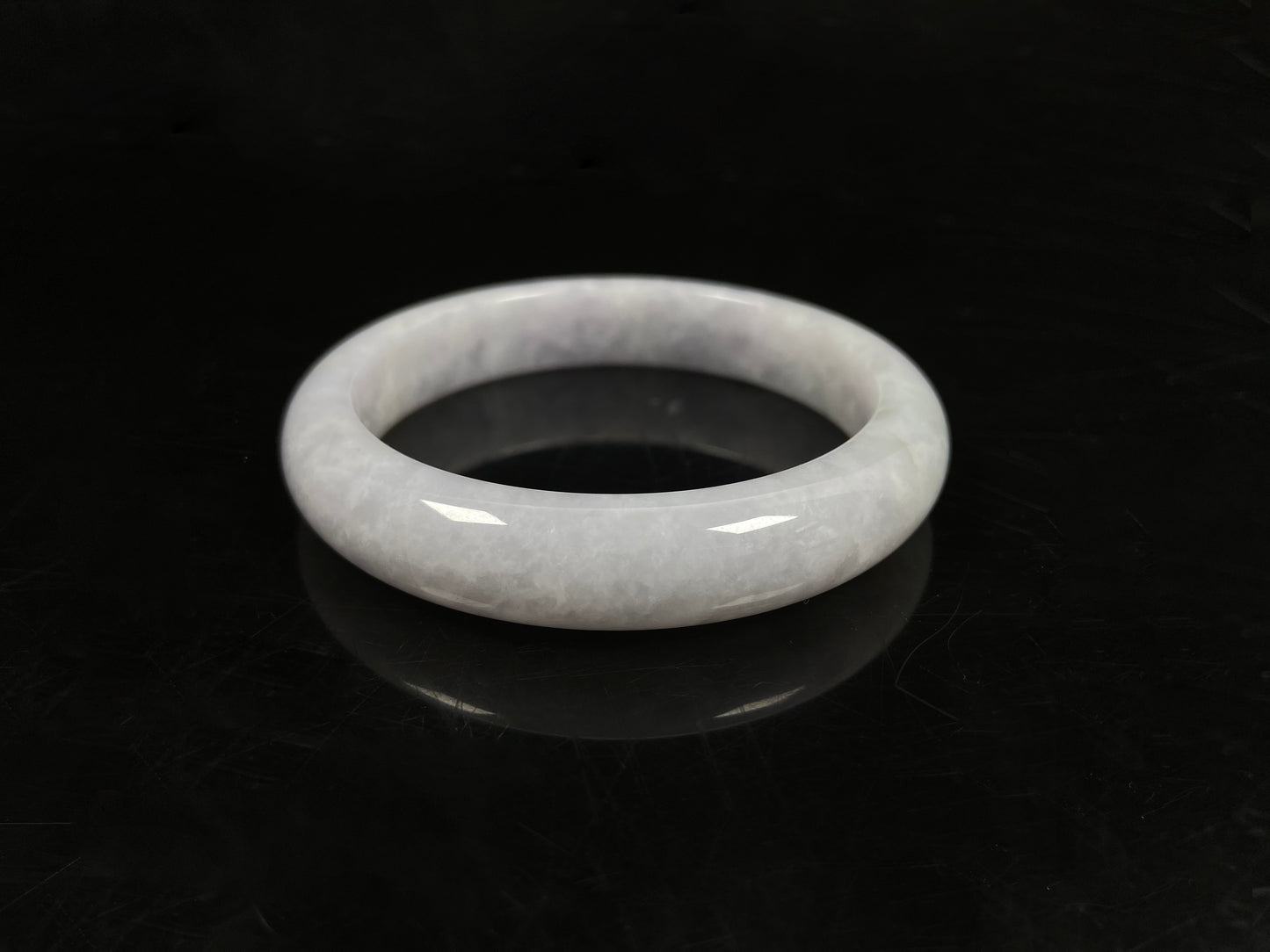 A milky white serenity jadeite bangle.