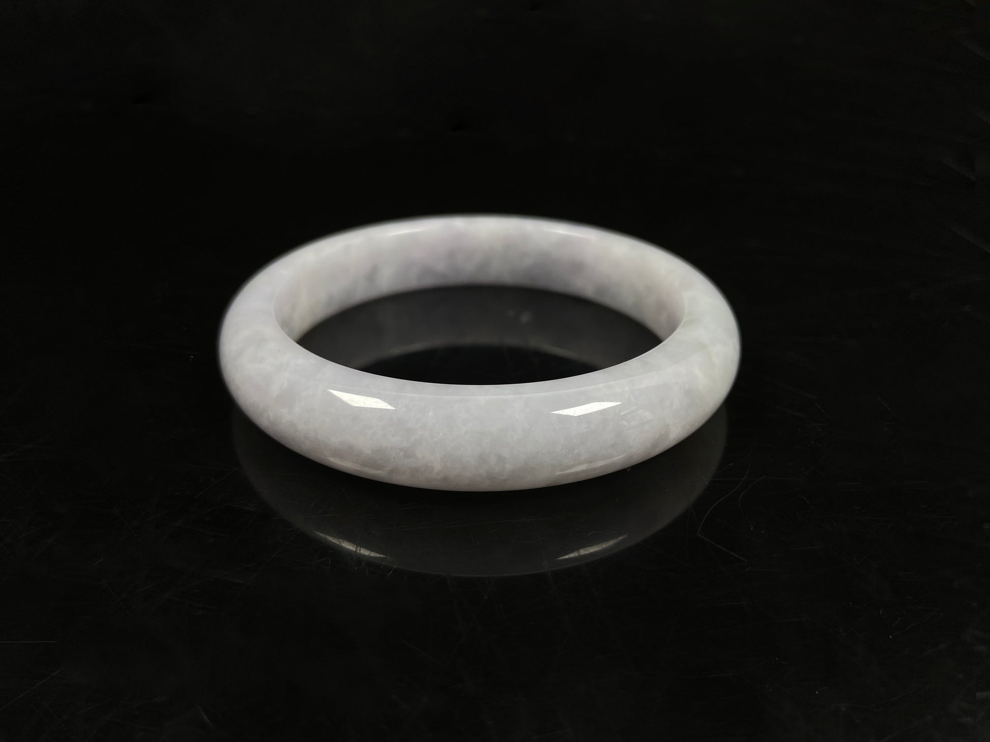 A milky white serenity jadeite bangle.