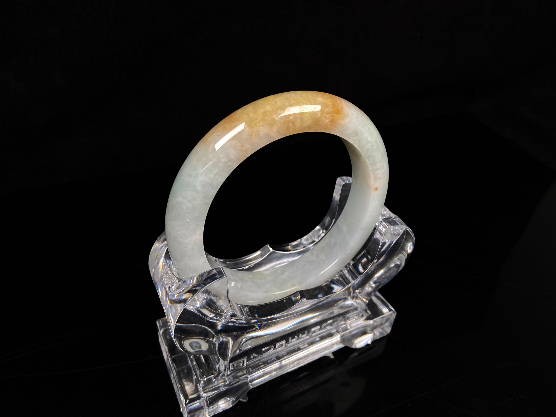 A light fernery gilded mist jadeite bangle.